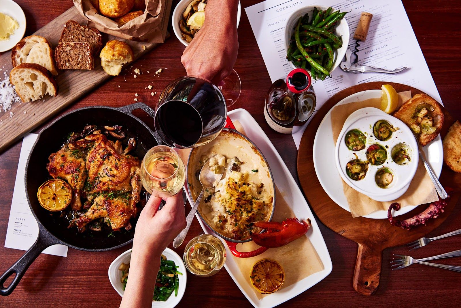 A table spread of Merriman's Honolulu dishes and drinks shared family-style.
