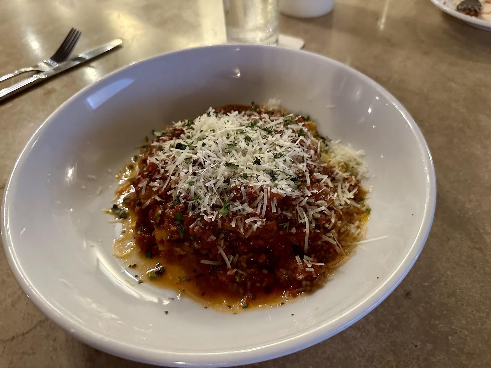 a pasta dish with red sauce and parmesan