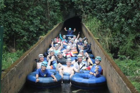 A group tubing the irrigation ditch on Kauai