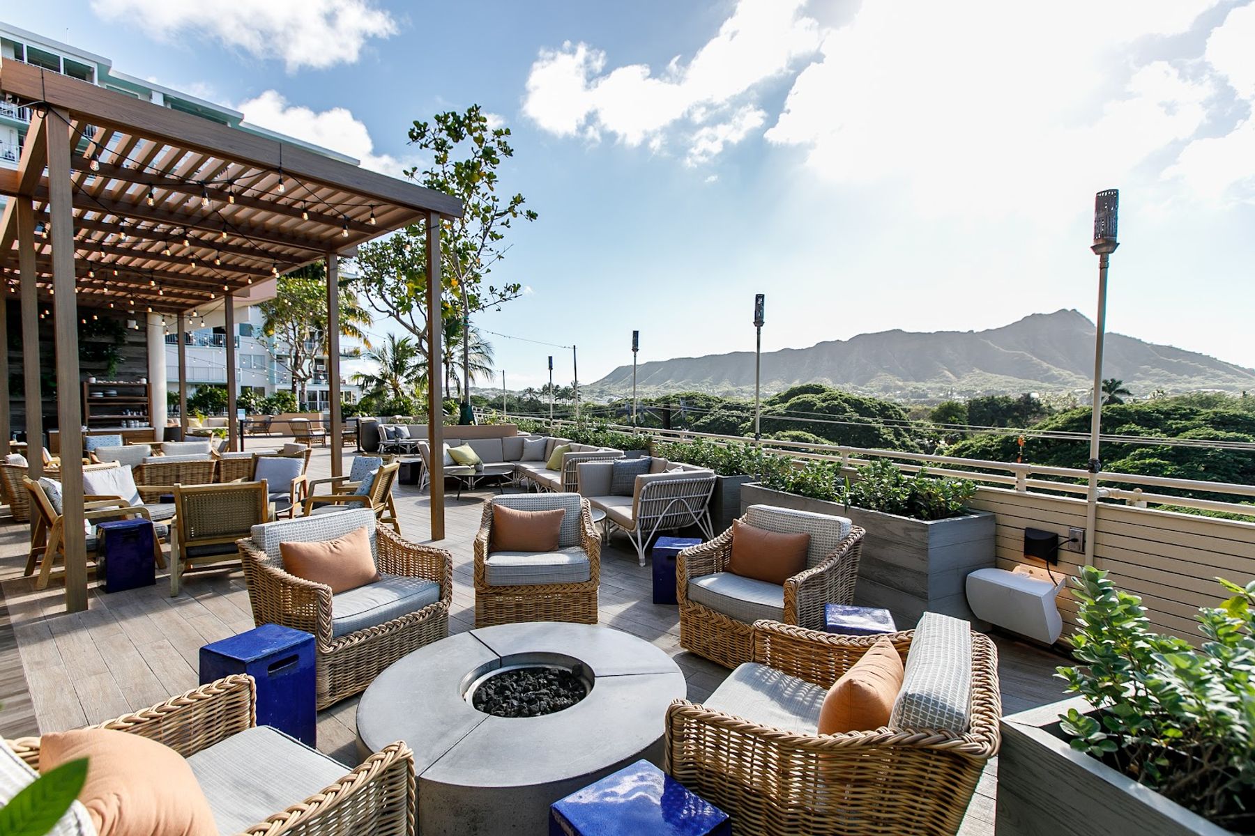 Open-air lounge seating at DECK. with Leahi visible beyond the terrace.