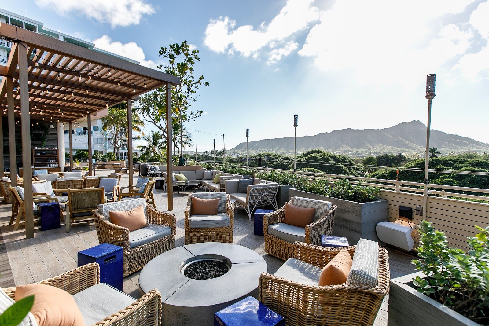 Open-air lounge seating at DECK. with Leahi visible beyond the terrace.
