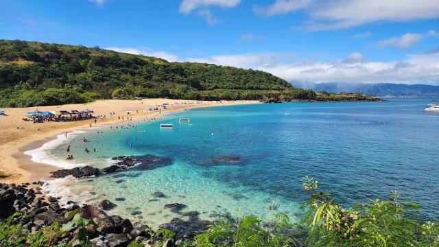 Wide blue water and sandy beach at Waimea Bay on Oahu's North Shore.