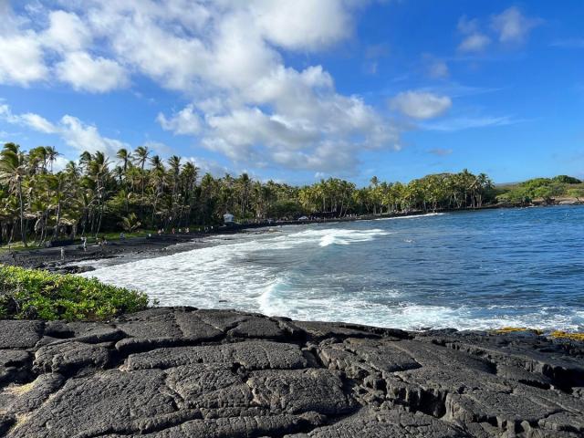 Black sand and blue water at Punaluʻu Beach on Hawaiʻi Island.