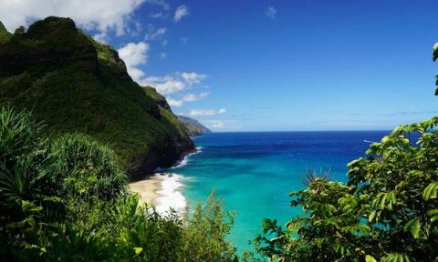 Breathtaking Na Pali Coast vista from the North Shore Kalalau Trail with dramatic sea cliffs and turquoise ocean