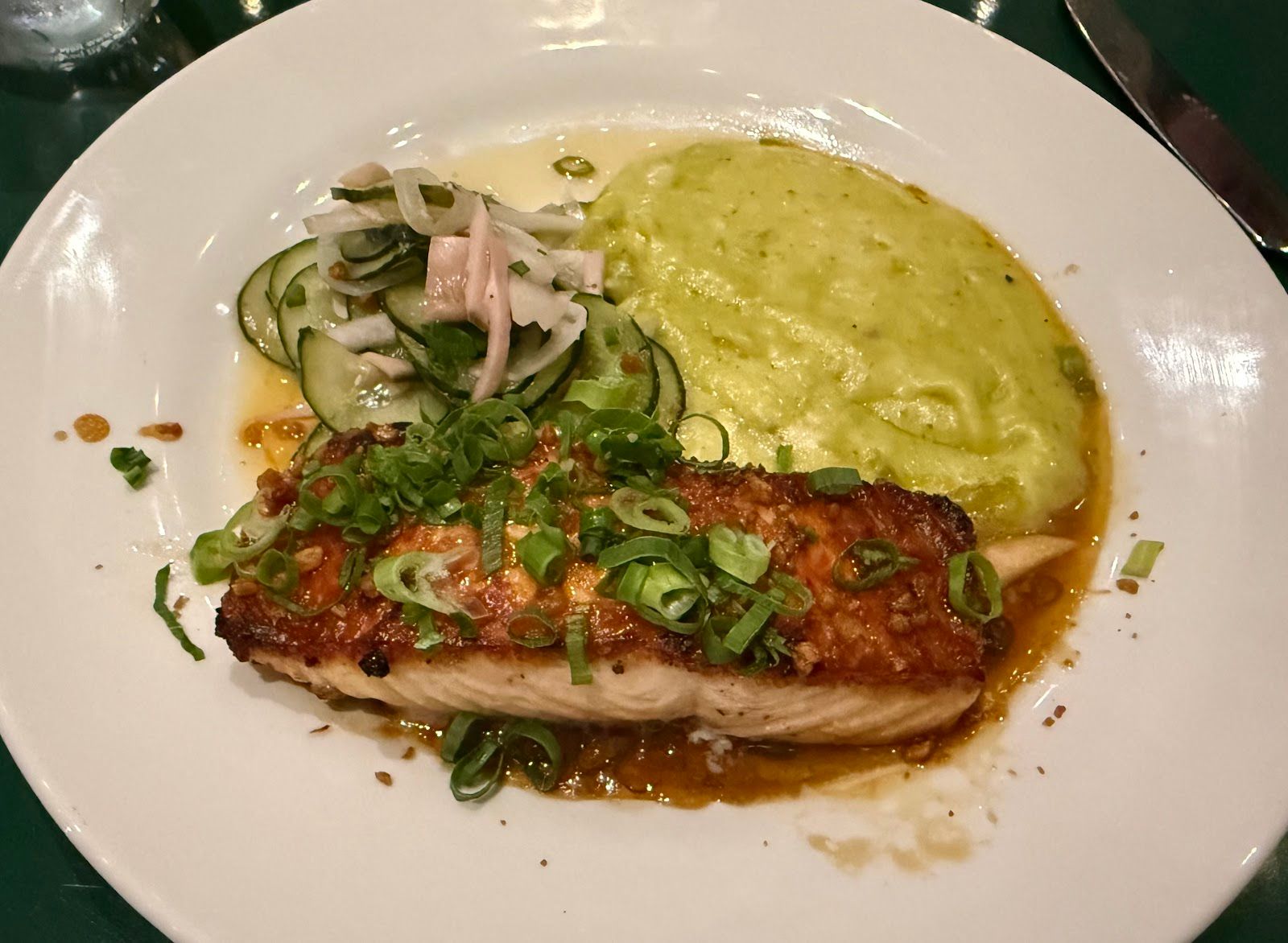 A plated seafood entree with green sauce at Merriman's Honolulu.