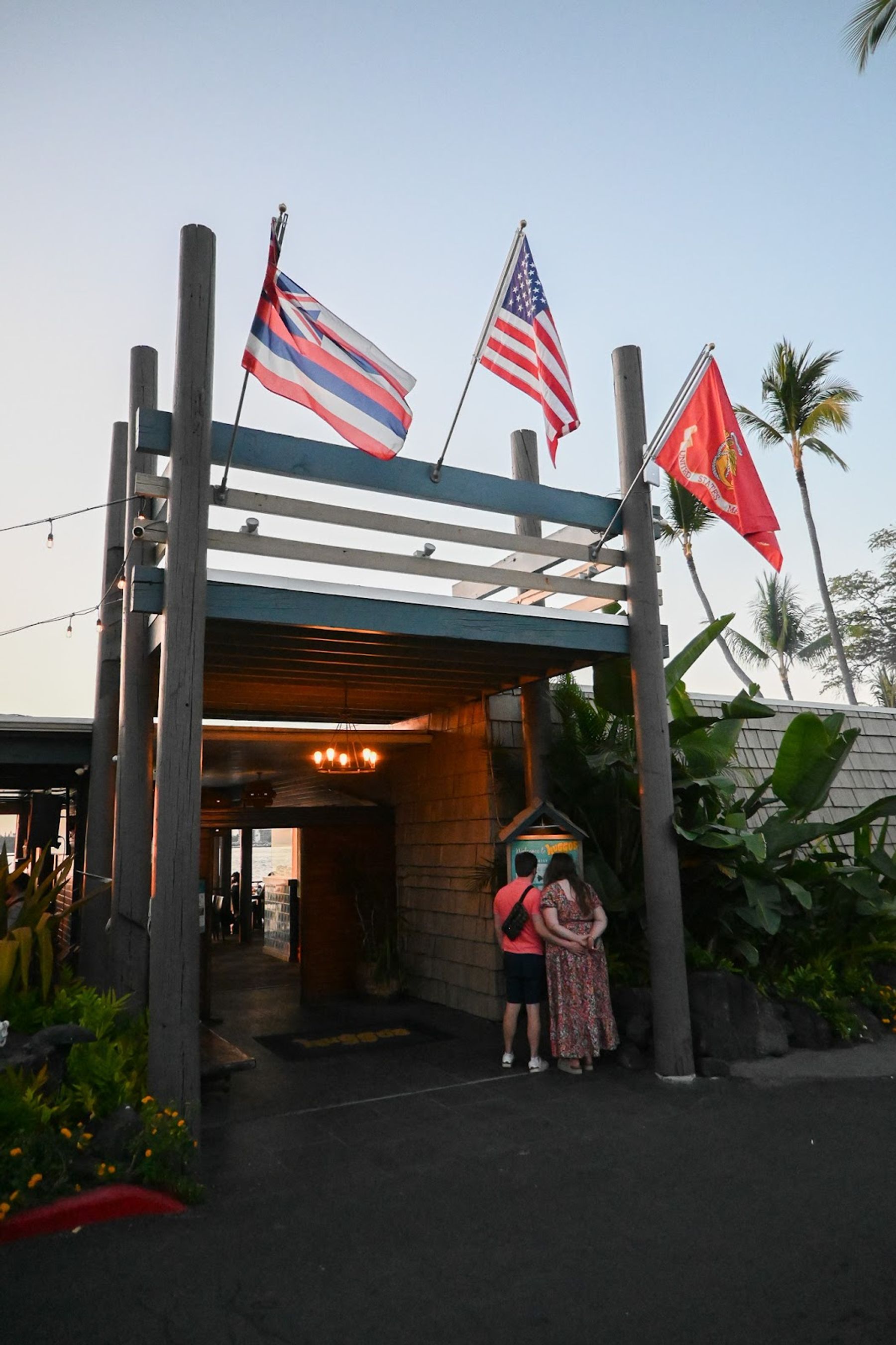 The entrance to Huggo's in Kailua-Kona with flags above the doorway.