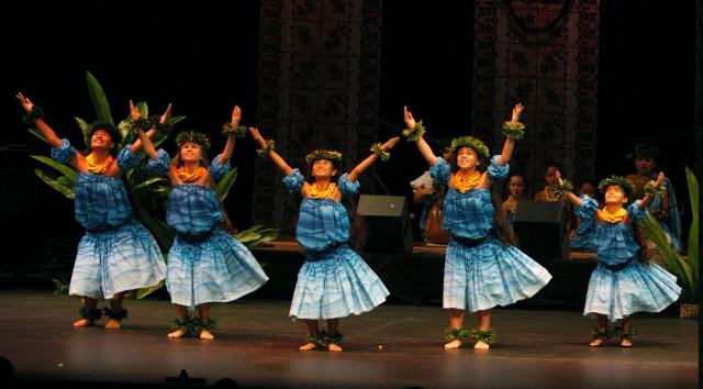a group of performers dancing hula
