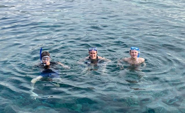 A family snorkels near Captain Cook Monument.