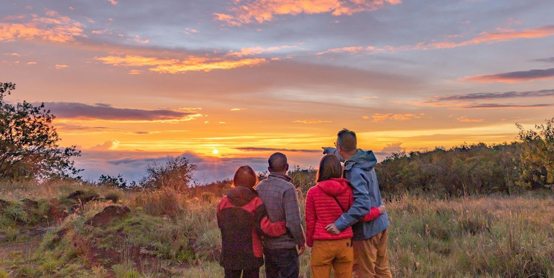 a family enjoying a sunset on the Big Island