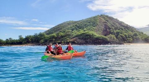 a family kayaking off Maui