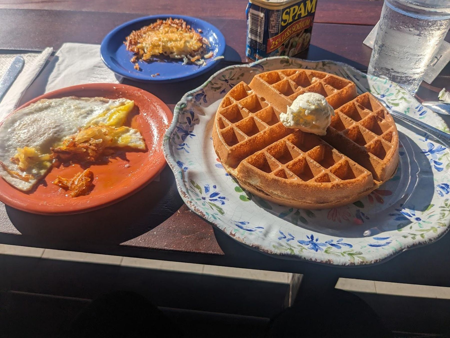 Classic Hawaiian breakfast spread with golden waffles, eggs, crispy hash browns, and SPAM