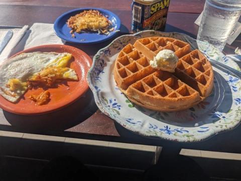 Classic Hawaiian breakfast spread with golden waffles, eggs, crispy hash browns, and SPAM