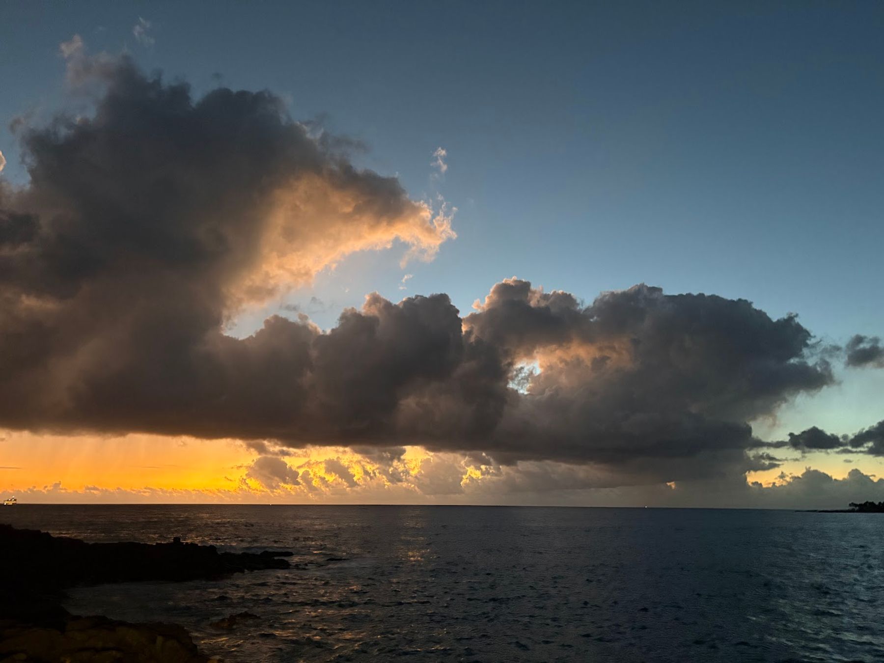 Clouds and sunset color over the ocean from Huggo's waterfront setting.