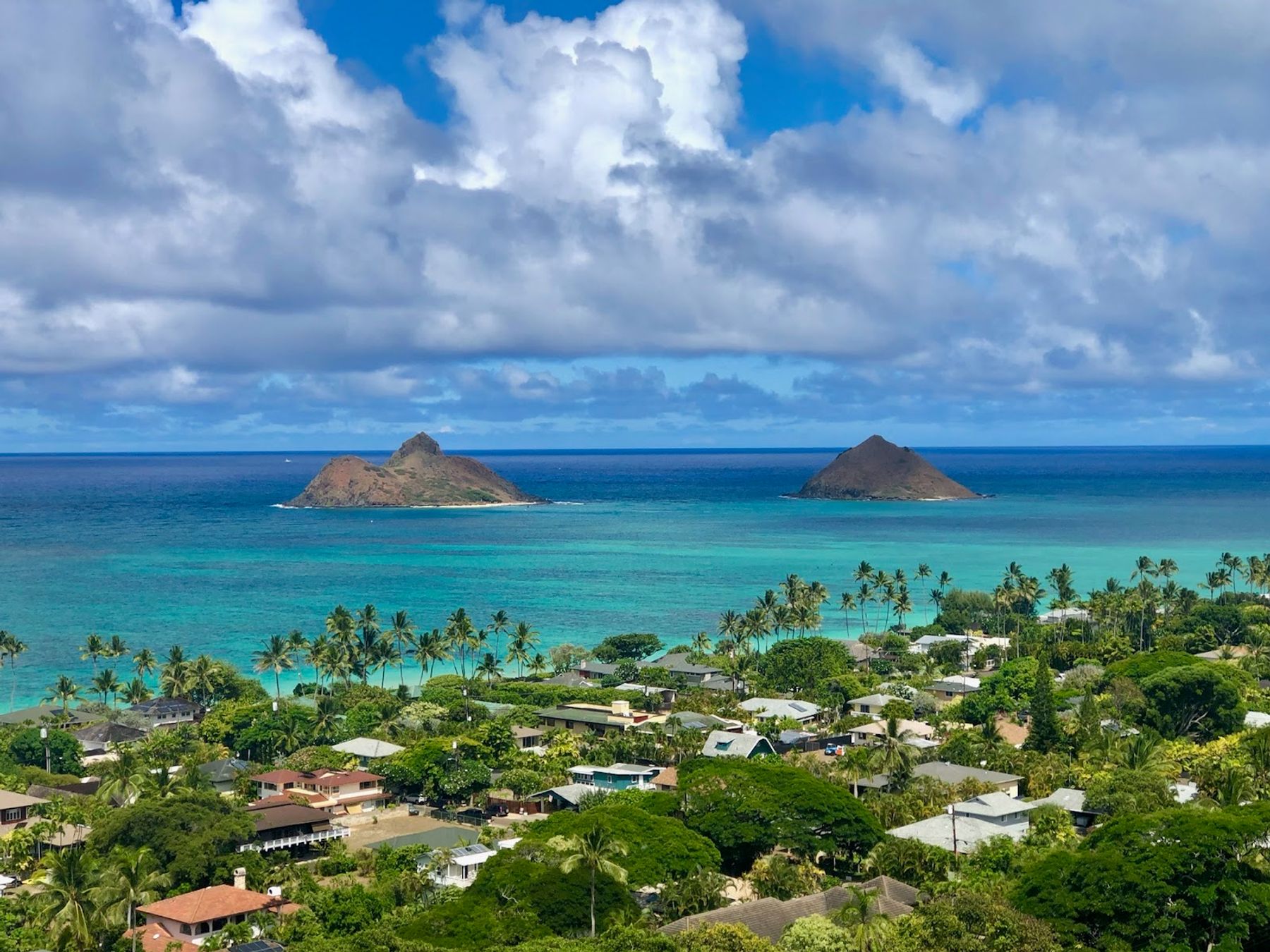 Lanikai Beach and the Mokulua Islands seen from the hillside above the Kailua and Lanikai neighborhood.