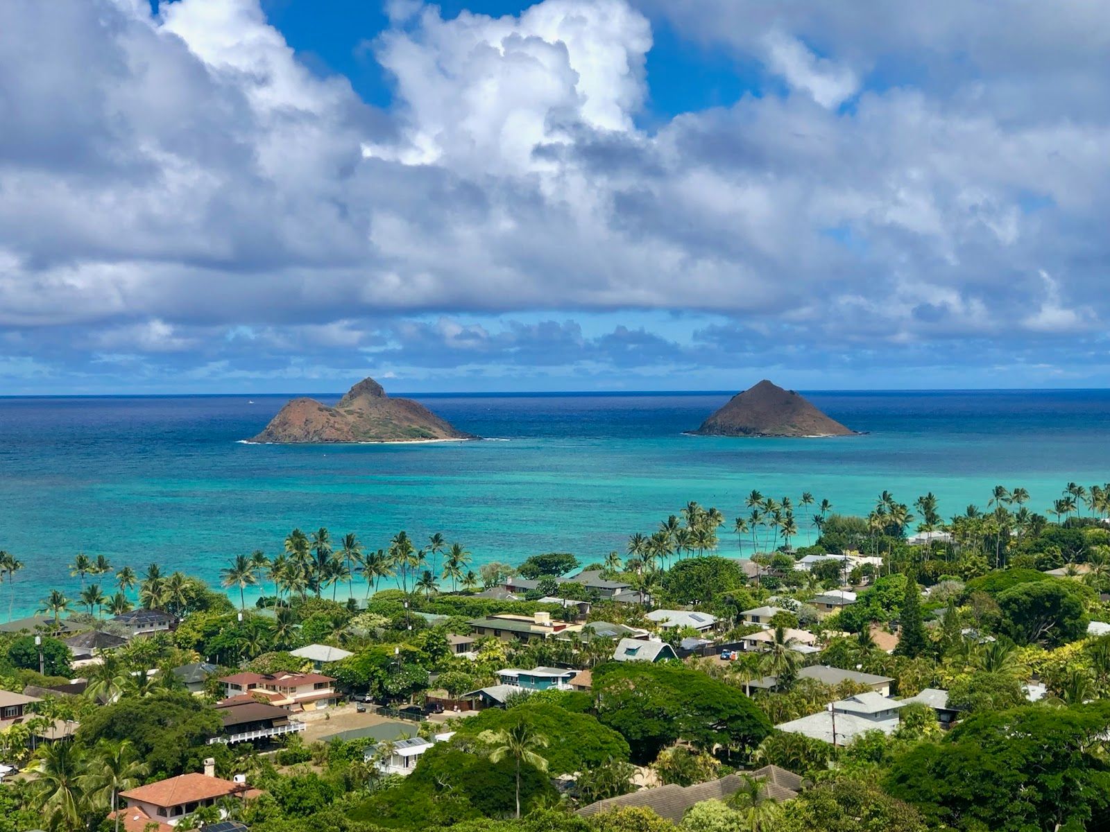 Lanikai Beach and the Mokulua Islands seen from the hillside above the Kailua and Lanikai neighborhood.