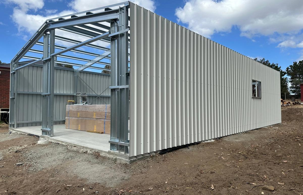 Steel frame going up for the Pontville garage, with the side wall clad and the front still open