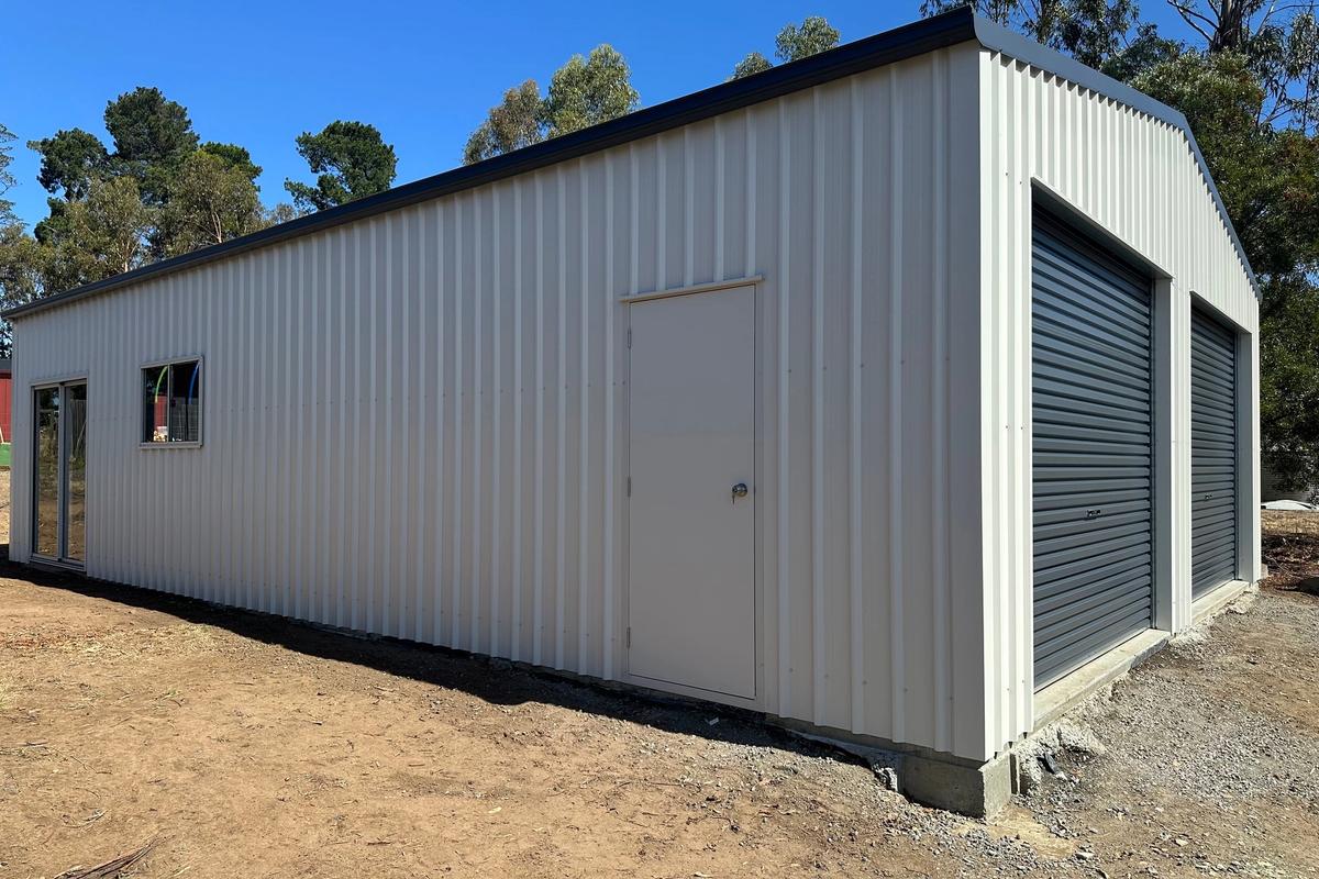 Side of the garage with the Surfmist walk-in door beside the front roller doors