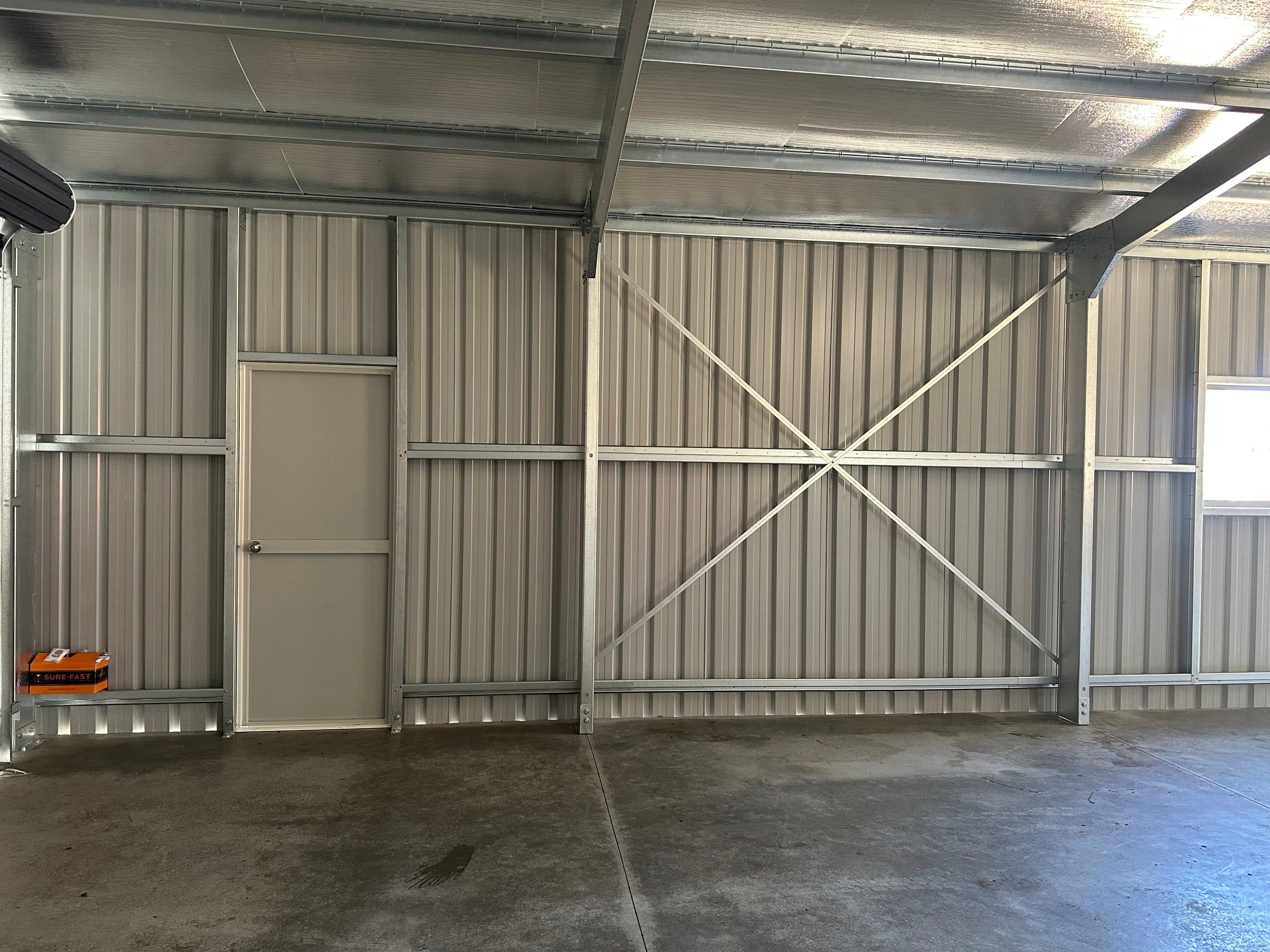 Walk-in door and wall cross-bracing inside the garage