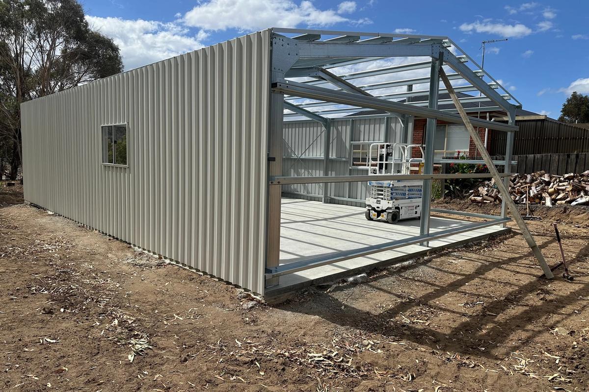 Garage mid-build with the walls clad and the roof framing still open