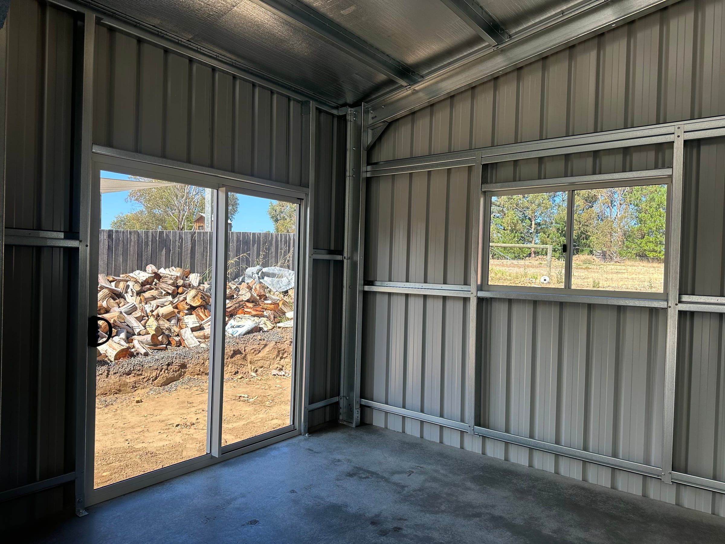 Sliding glass door and window in the back corner, looking out to the yard