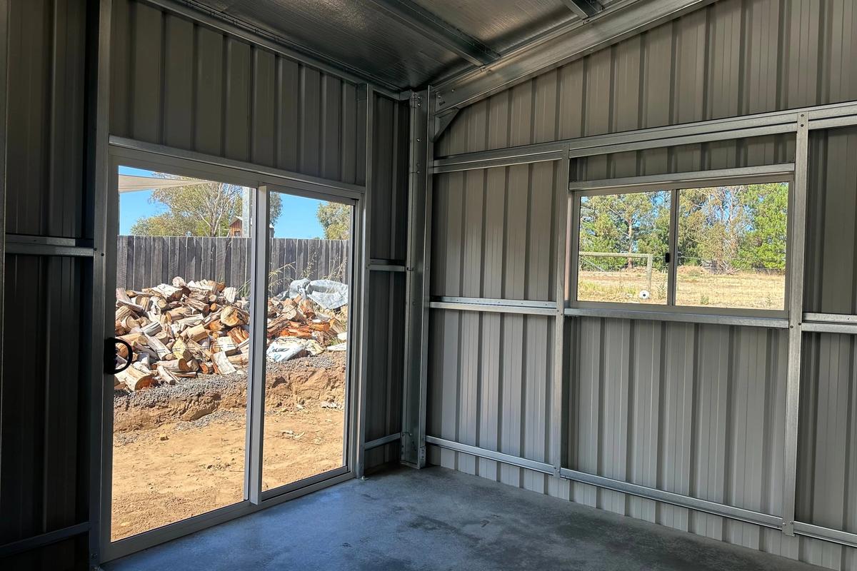 Sliding glass door and window in the back corner, looking out to the yard