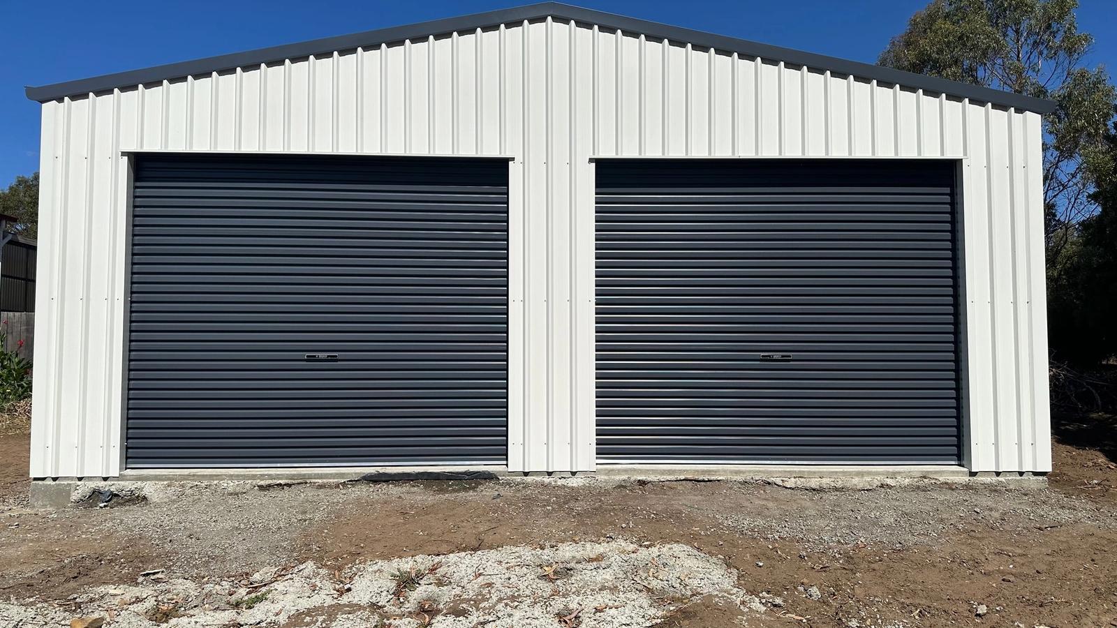 8m x 12m Colorbond garage in Pontville with two Ironstone roller doors and Surfmist walls