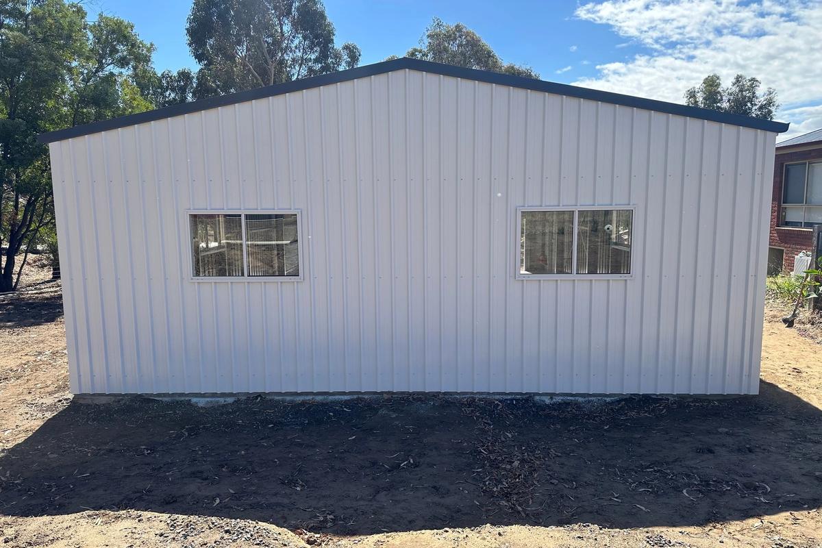 Rear wall of the garage with two sliding windows under the Ironstone roof