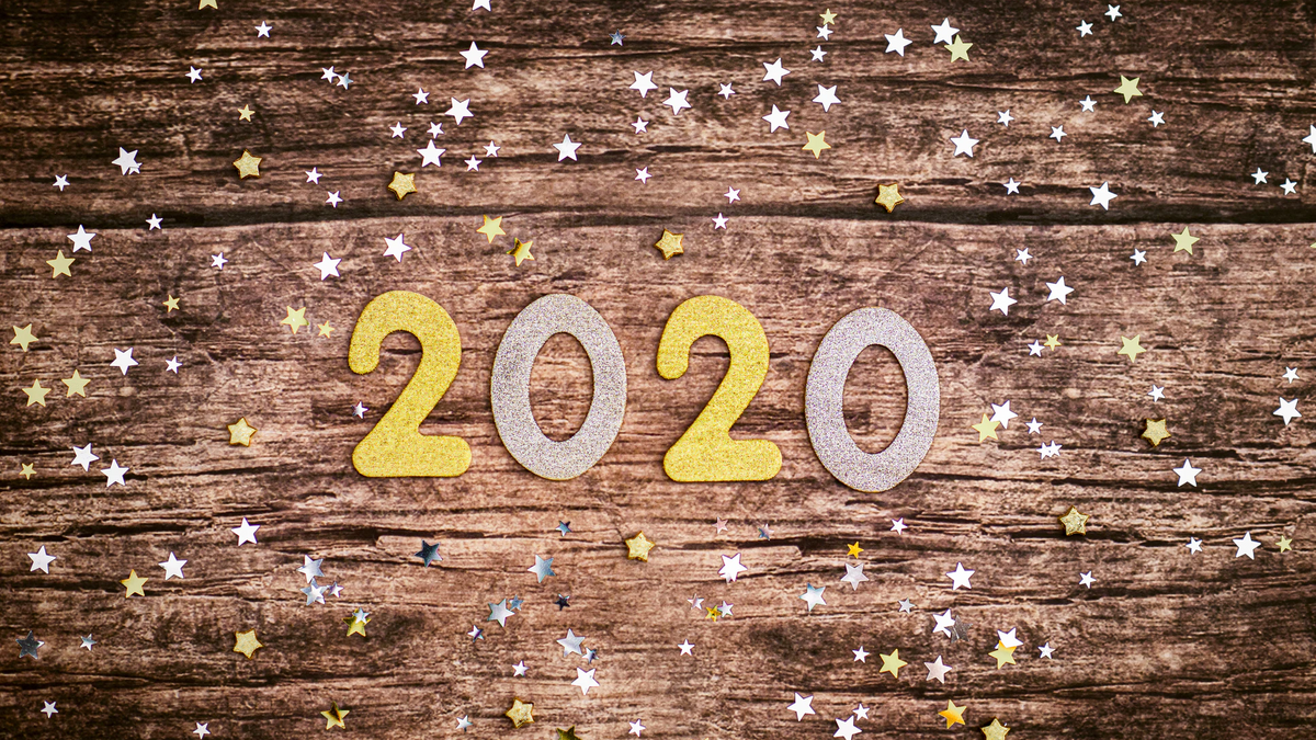 A rough wooden table with the 2020 placed among them in large plastic letters