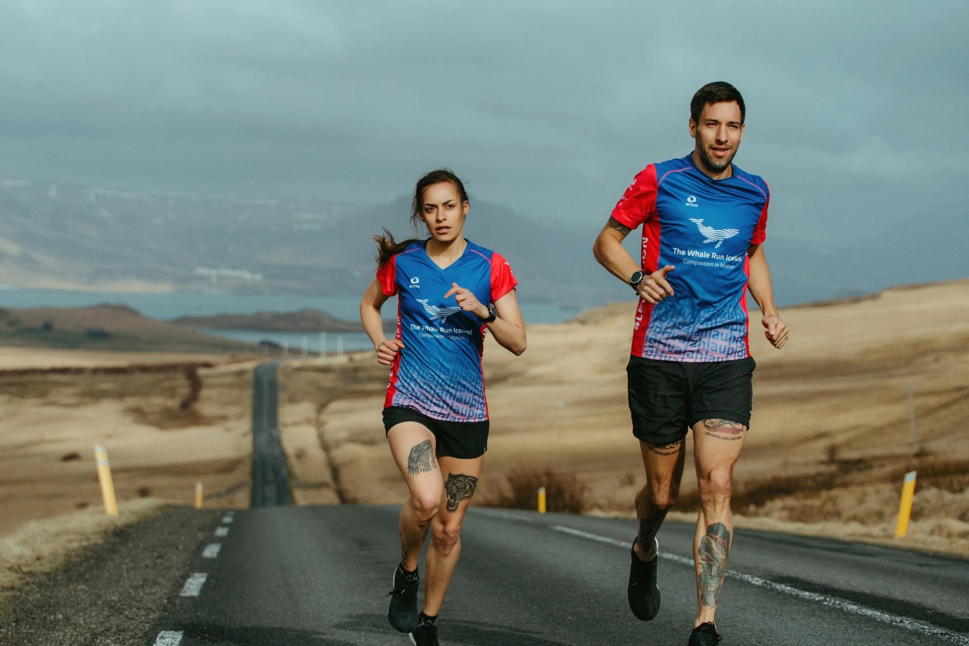 Two runners in The Whale Run Iceland jerseys running toward the camera — Björn Lexius, Iceland