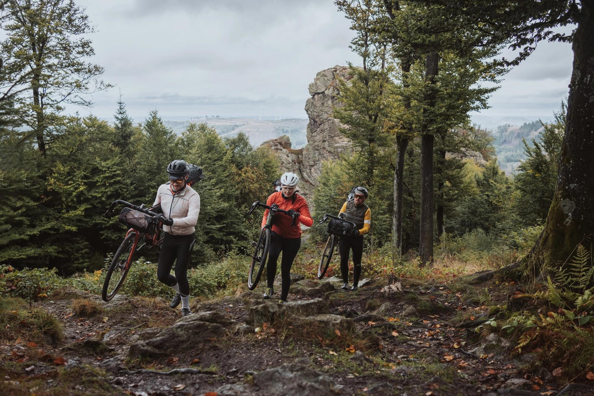 Riders carrying bikes — Björn Lexius, Sauerland, Germany