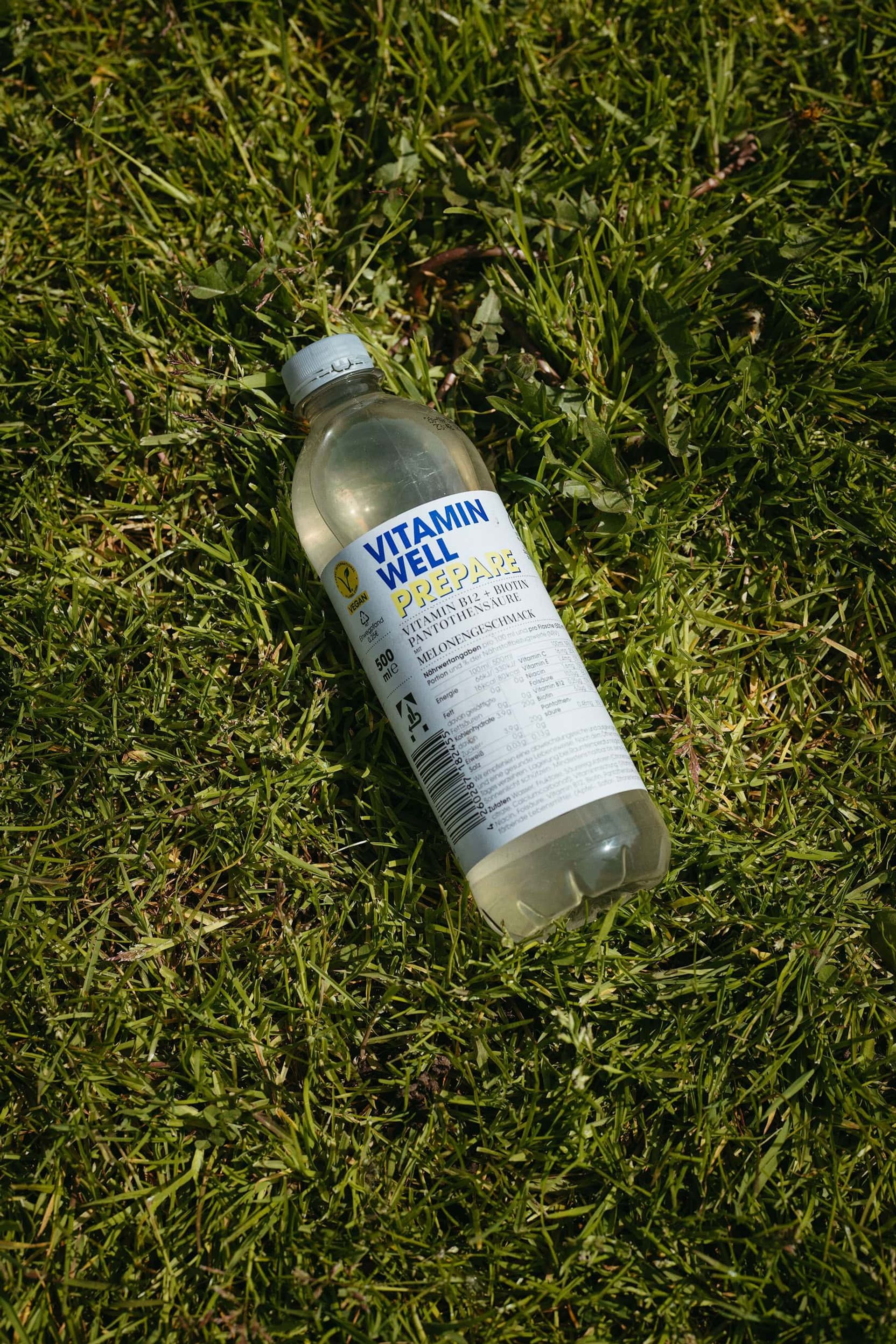 Vitamin Well Prepare bottle lying in grass — Björn Lexius, Hamburg