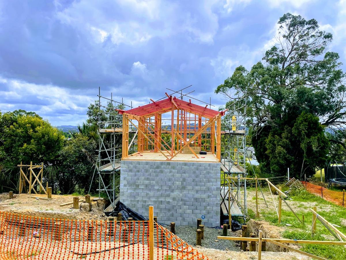 Roof framing over the concrete block base during construction