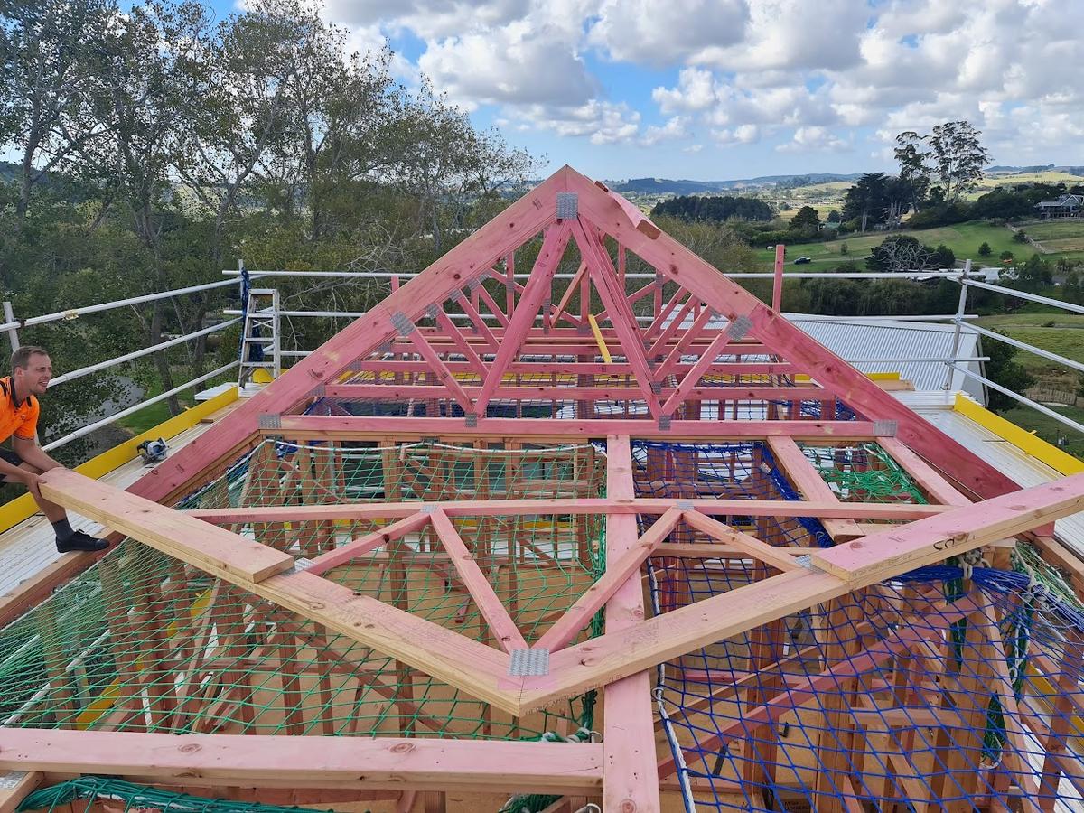 Roof trusses in place, looking out over the surrounding farmland