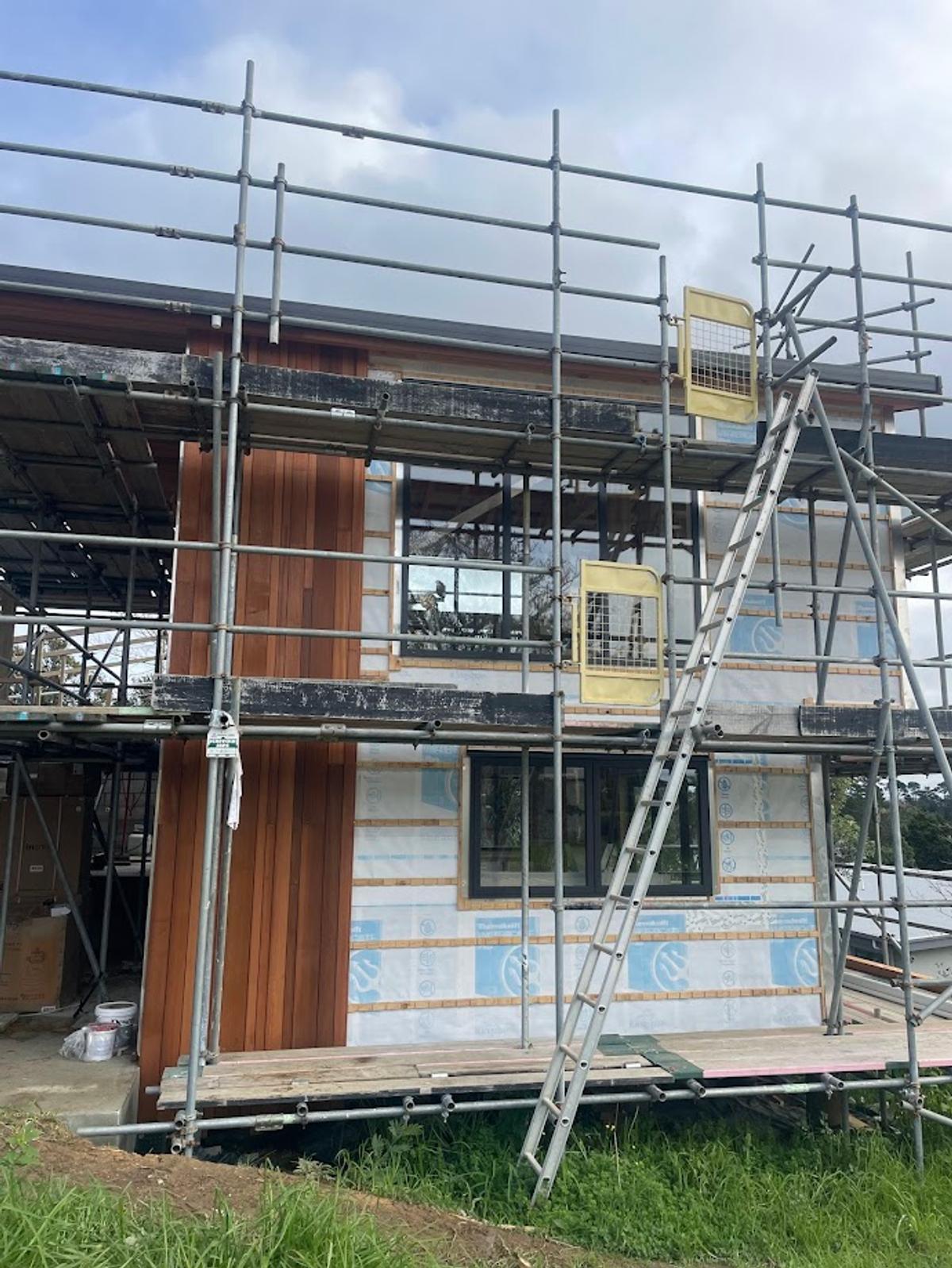 Cedar cladding part way installed over the building wrap