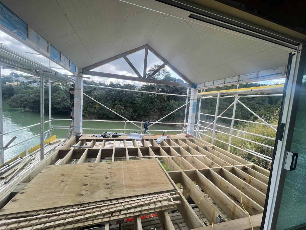 Floor joists and framing, looking out to the estuary through the gable opening