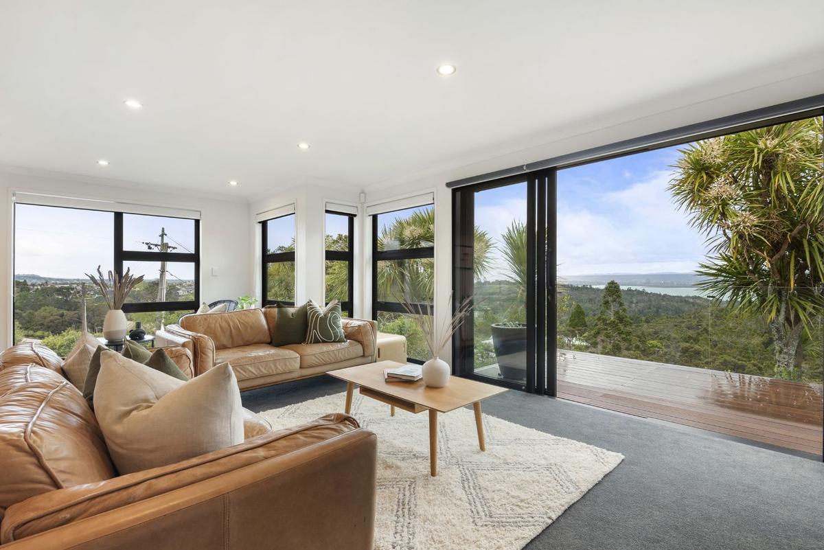 Living room opening to the deck, with a view out to the harbour