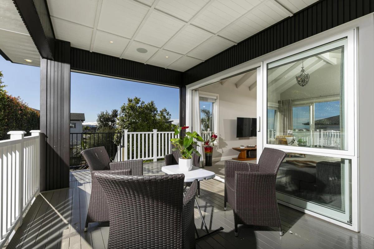 Covered deck with outdoor dining, looking out over the neighbourhood