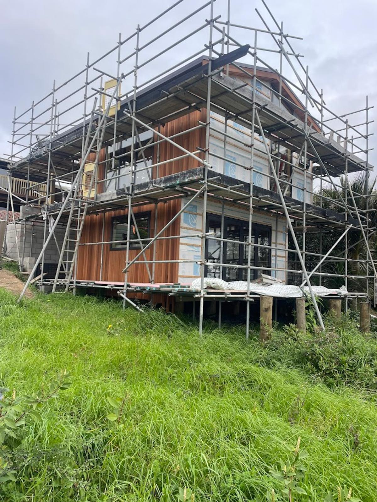 Cedar cladding going on, with the building fully scaffolded