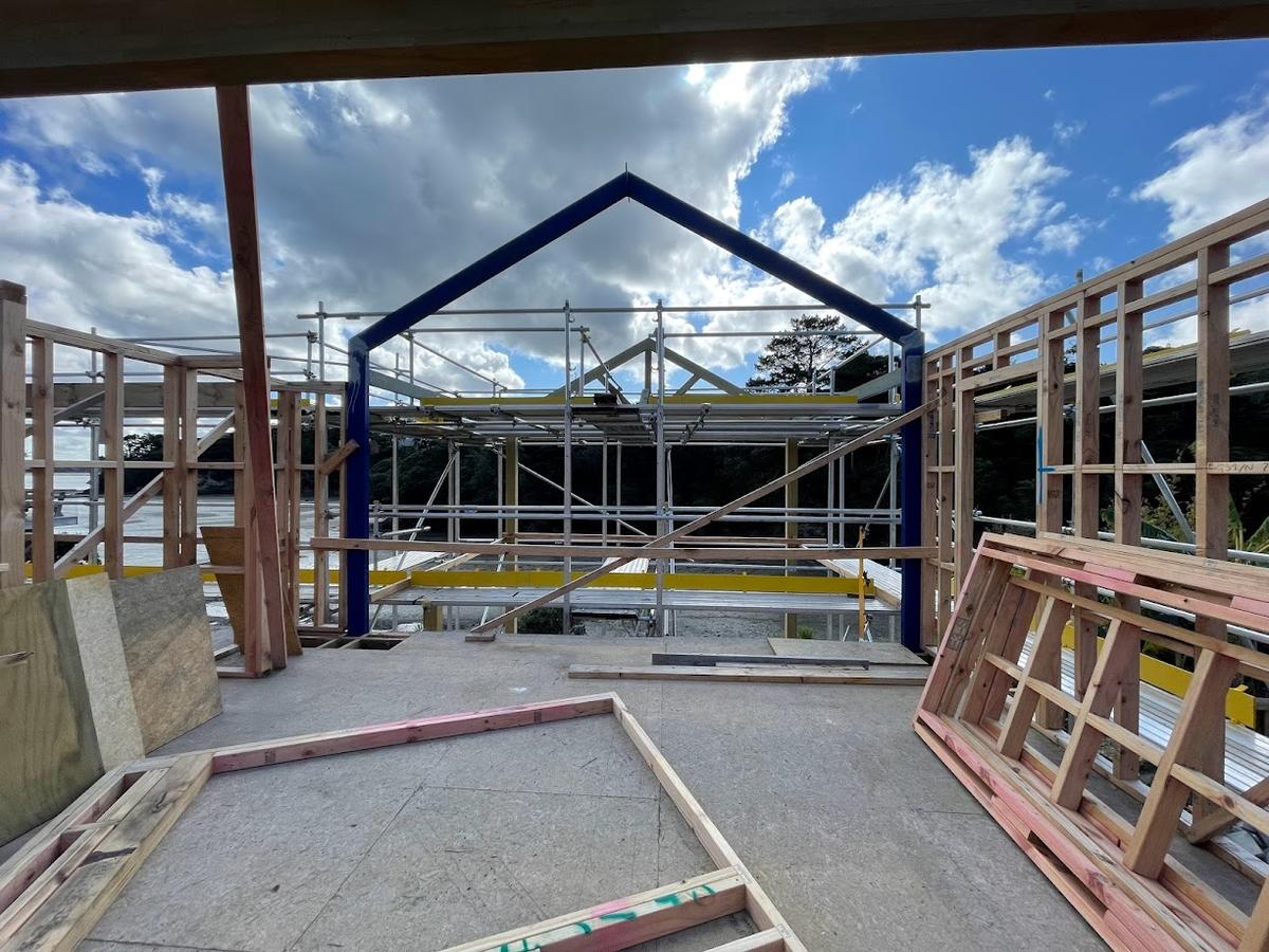 Steel portal frame and gable framing seen from inside the build