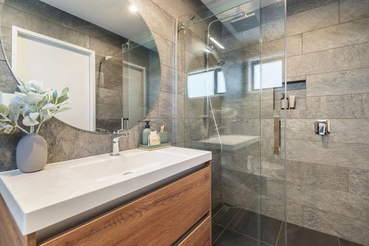 Bathroom with a walk in tiled shower and timber vanity