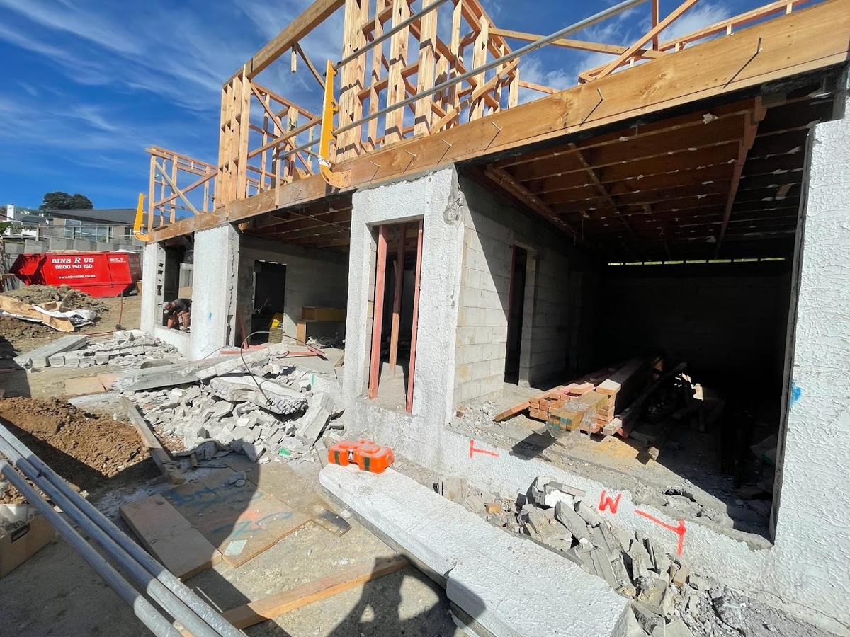 Concrete block lower level complete, with framing started above