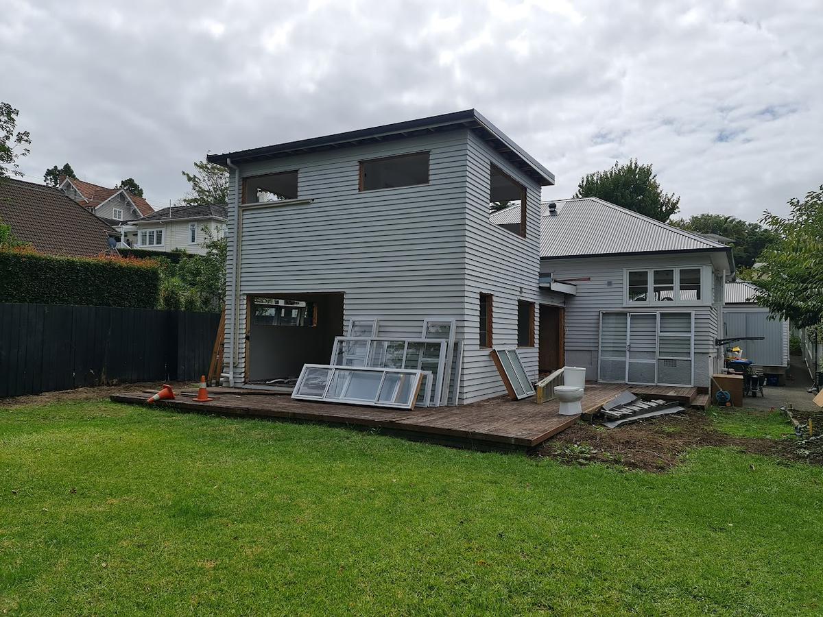 Rear elevation part way through the build, cladding on and joinery stacked on the deck