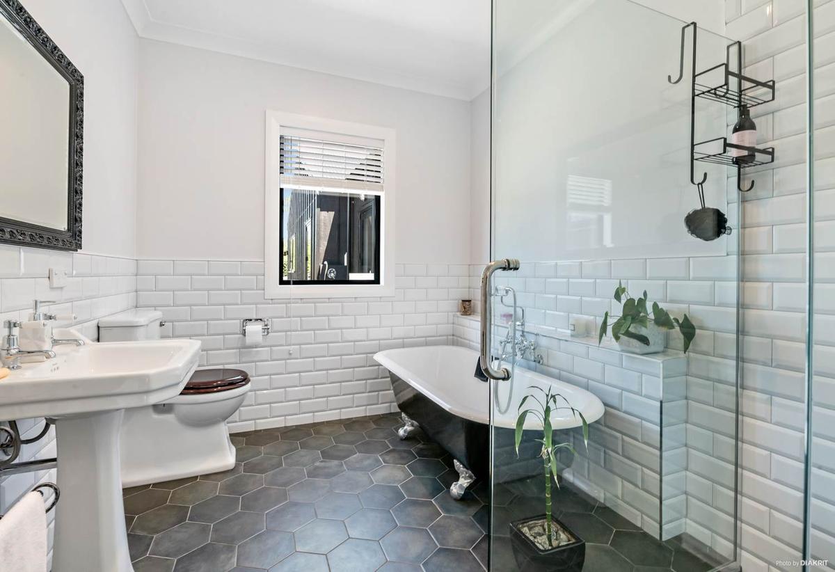 Bathroom with a clawfoot bath, subway tiles and hexagonal floor tiles