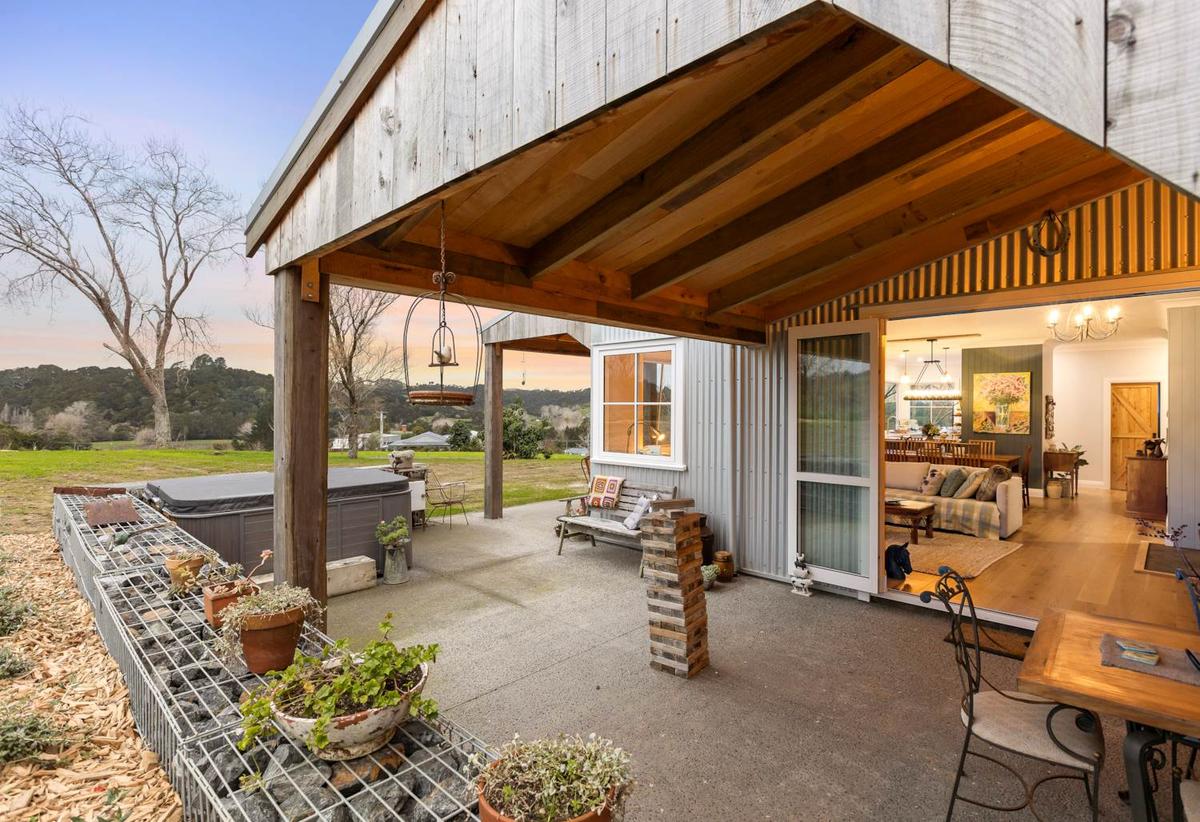Covered patio at dusk, looking through to the living room