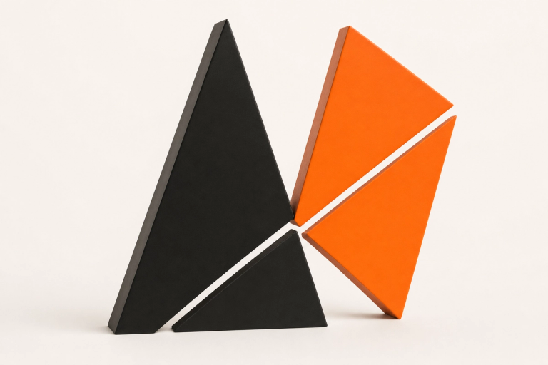 Four matte ceramic triangles, two ink black and two tangerine, standing as thick blocks split by a clean diagonal cut, the AgentBuild mark in three dimensions.