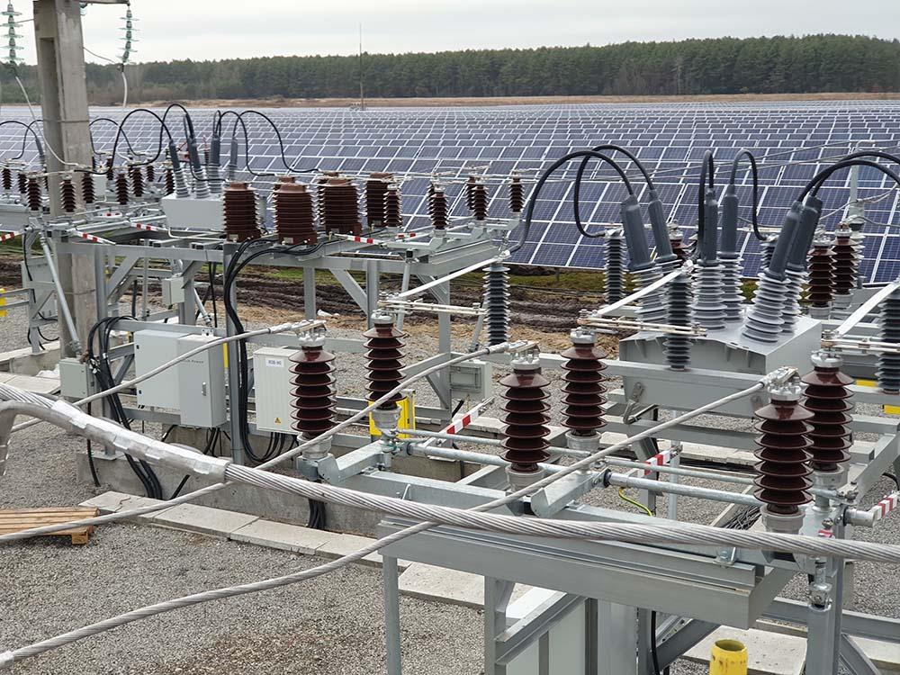 Electrical substation equipment with NOJA Power OSM Reclosers installed, in front of solar farm in Ukraine 