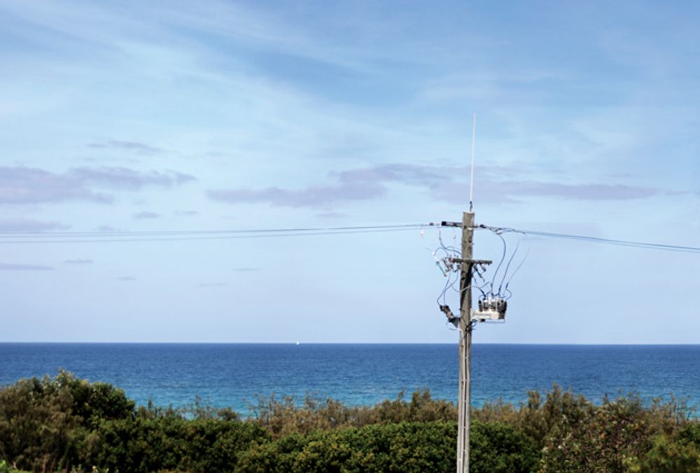 NOJA Power OSM Recloser with the ocean and blue skies behind the installation