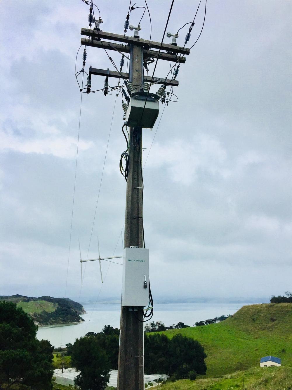 New Zealand installation of RC10-200 Control System on a legacy OSM Recloser on a hill with the sea in the background