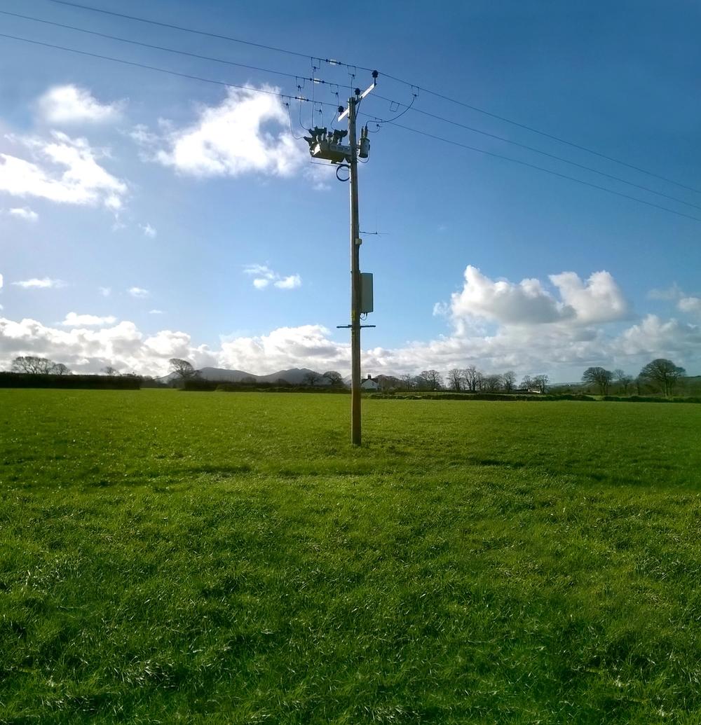 OSM Recloser with RC10 Recloser Controller on green grass field in the United Kingdom