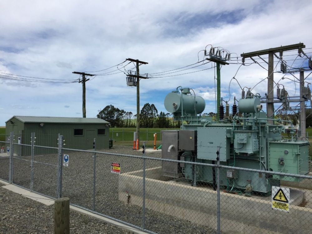NOJA Power OSM Recloser installation behind a fence in a New Zealand Substation, with a green shed in the background